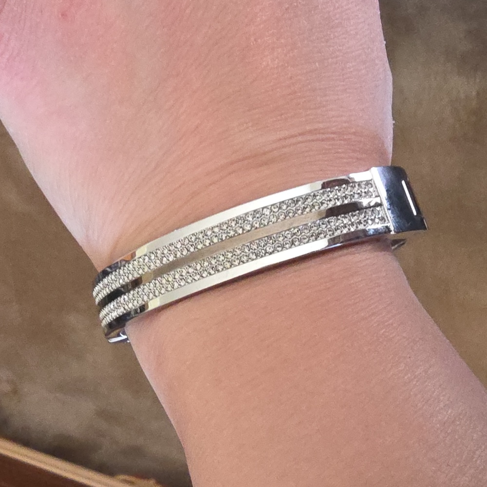 Michael Kors silver-tone hinged bangle bracelet with pavé crystal accents. 